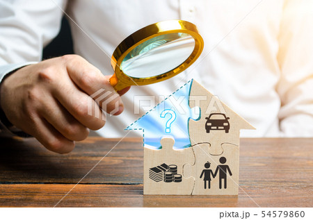 A man examines the missing piece of the puzzle A man examines the missing piece of the puzzle 54579860
