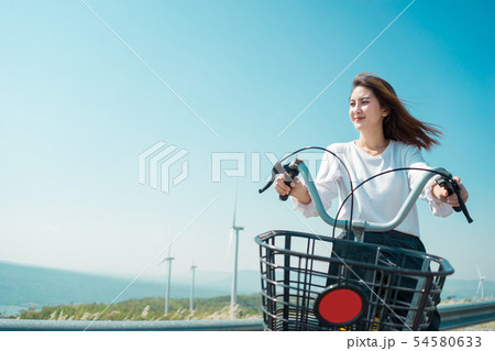 Young woman riding bicycle on the mountain. 54580633
