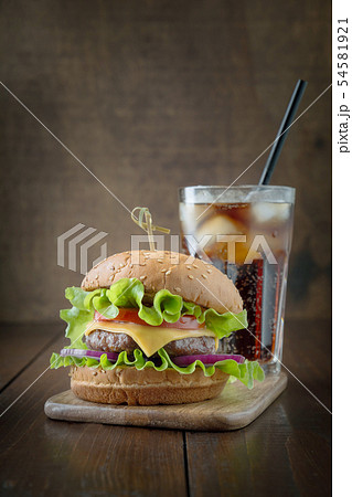 Fresh two beef burgers with cola on wooden board. 54581921
