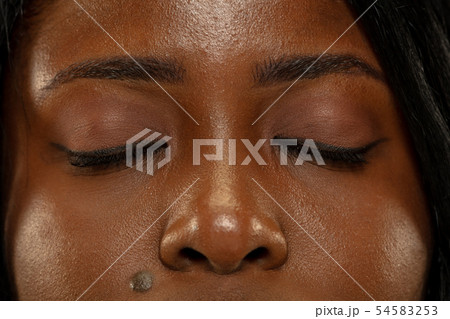 Young african woman isolated on yellow studio background, facial expression Young african woman isolated on yellow studio background, facial expression 54583253