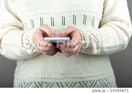 Woman using white smartphone. 54584871