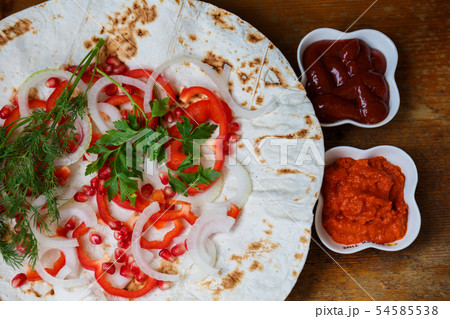 Red bell peppers, onions, pomegranate and parsley Red bell peppers, onions, pomegranate and parsley 54585538