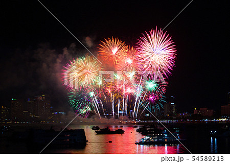 final rainbow fireworks on beach and reflection 54589213