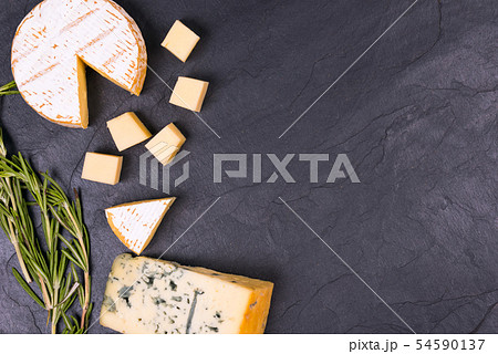 Cheese with mold with a sprig of thyme on a slate Board Cheese with mold with a sprig of thyme on a slate Board 54590137