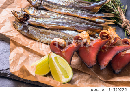 Snack. Dry fish on the table in paper ready to eat 54590226