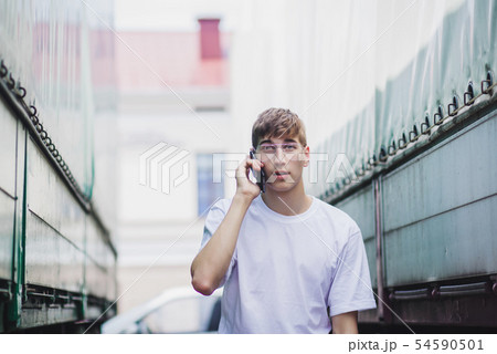 a young man in an empty white t-shirt a young man in an empty white t-shirt 54590501
