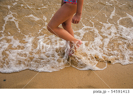 Child legs walking on sand and sea water on beach Child legs walking on sand and sea water on beach 54591413