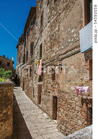 Narrow alley with old buildings and lamps 54593059