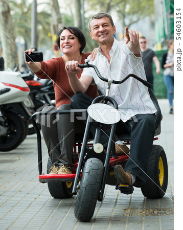 couple driving double bike 54603154