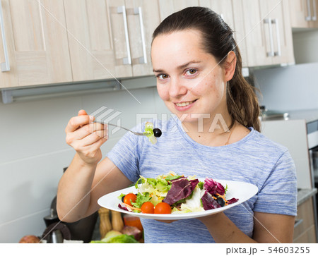 portrait woman eating salad 54603255