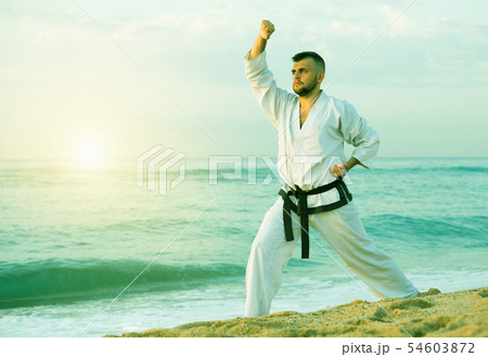 Man is exercising to doing the Kokutsu-dachi stance Man is exercising to doing the Kokutsu-dachi stance 54603872