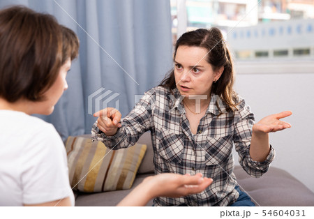 Woman pointing to mistakes to her elderly sister while quarrel Woman pointing to mistakes to her elderly sister while quarrel 54604031