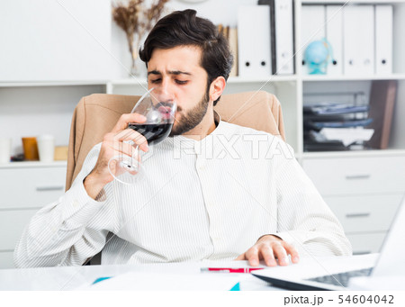 Manager with glass of wine Manager with glass of wine 54604042