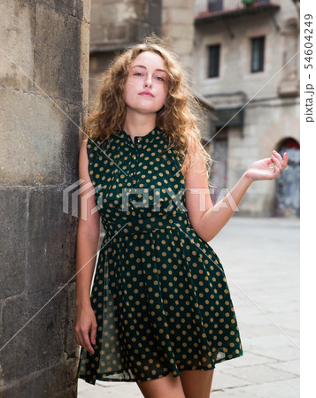 Young sexy woman in dress standing near the stone wall in historical center Young sexy woman in dress standing near the stone wall in historical center 54604249
