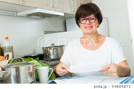 cheerful woman paying bills 54604873