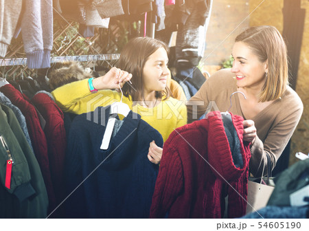 Teenager-girl and mother are looking for trendy sweaters Teenager-girl and mother are looking for trendy sweaters 54605190