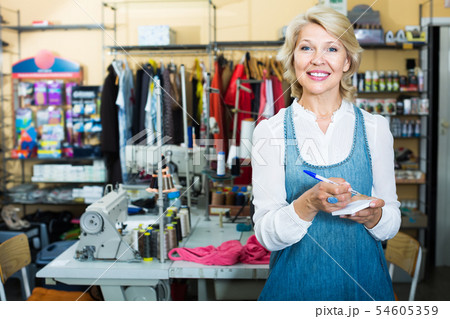mature woman tailor in sewing studio. mature woman tailor in sewing studio. 54605359