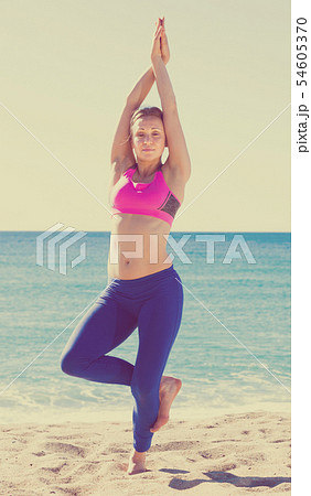Pretty healthy woman stretching body Pretty healthy woman stretching body 54605370