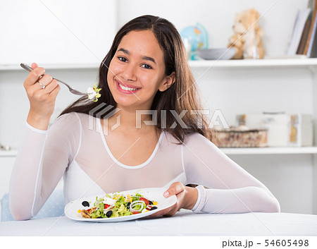 Smiling girl eating tasty sala Smiling girl eating tasty sala 54605498