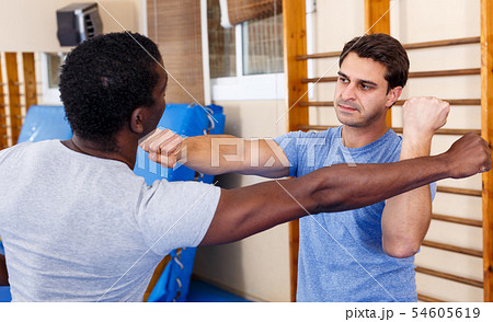 Two men practicing self defense techniques Two men practicing self defense techniques 54605619