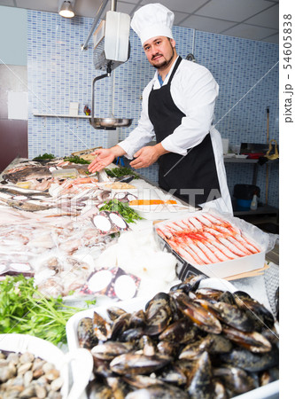 Standing positive man shows the fish counter Standing positive man shows the fish counter 54605838