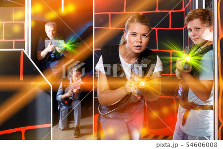 Happy teen boy having fun on laser tag arena with his older sist 54606008