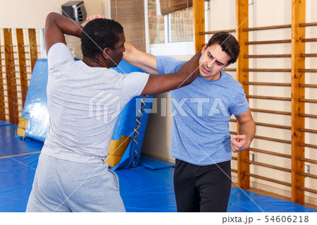 Two men practicing self defense techniques 54606218