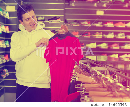 Man is looking on modern shirt for sport Man is looking on modern shirt for sport 54606548