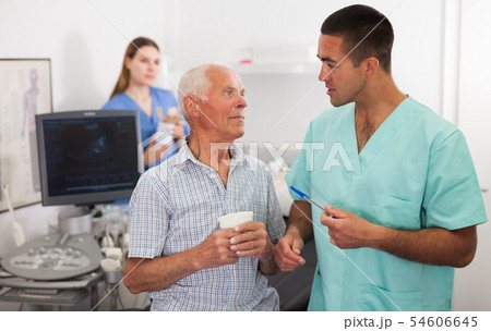 Sonographer talking with man before procedure Sonographer talking with man before procedure 54606645