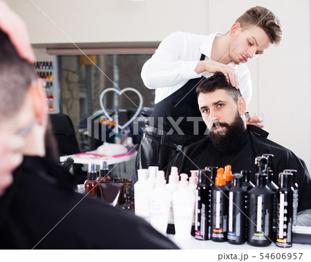 Client looking displeased about new haircut Client looking displeased about new haircut 54606957
