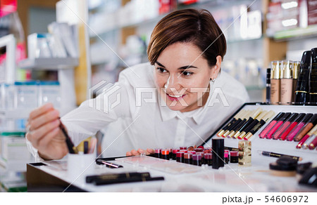 Female customer searching for reliable make-up products Female customer searching for reliable make-up products 54606972