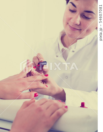 Woman doing manicure 54607081