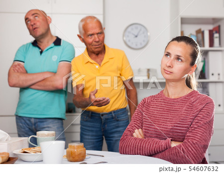 Elderly father together with his adult son scold the daughter-in-law at home 54607632