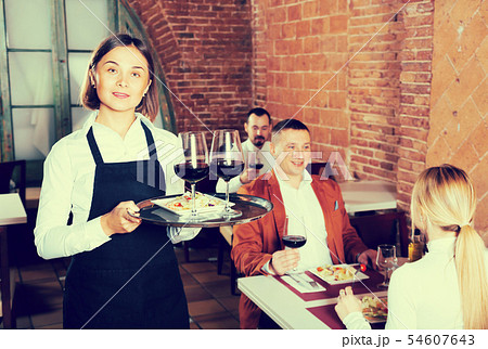 Happy female waiter showing country restaurant Happy female waiter showing country restaurant 54607643