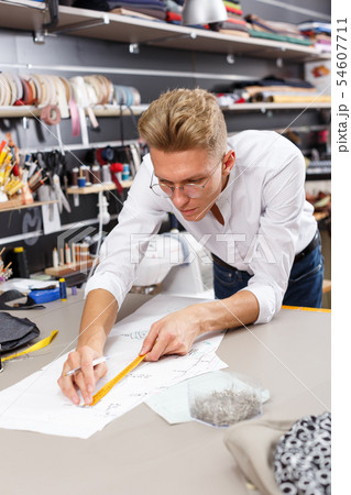 Dressmaker at work – creating pattern 54607711