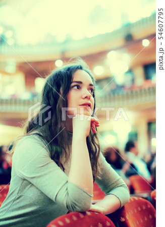 Portrait of woman sitting in theatre salon 54607795