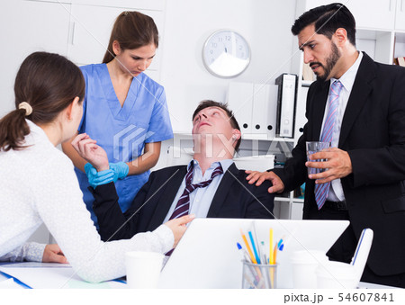 Man receiving first aid in office 54607841