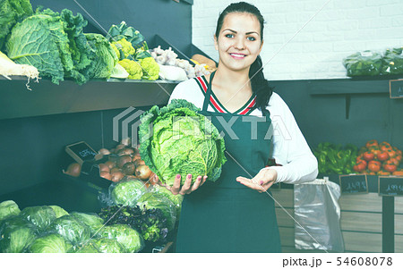 Woman choosing cabbage in grocery shop Woman choosing cabbage in grocery shop 54608078