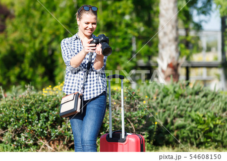 Happy woman traveler making photo of sights Happy woman traveler making photo of sights 54608150