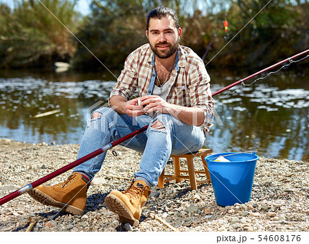 Bearded fisherman prepares fishing gear Bearded fisherman prepares fishing gear 54608176