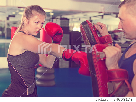Woman training punch in gym Woman training punch in gym 54608178
