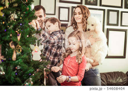 Family decorating Christmas tree 54608404