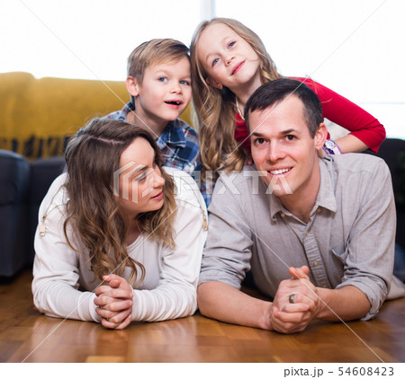 Smiling family enjoying evening together at home 54608423