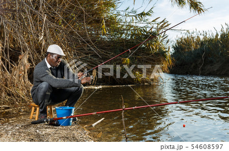 Fisherman sitting on wooden stool Fisherman sitting on wooden stool 54608597