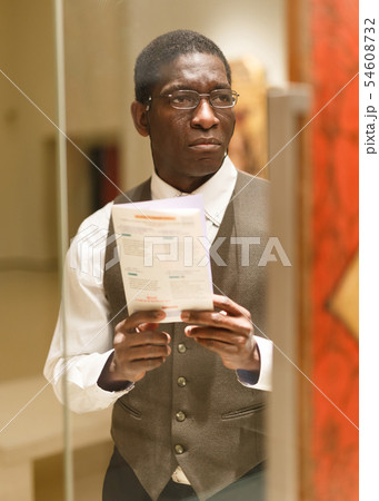 Man with guidebook at Art Museum 54608732