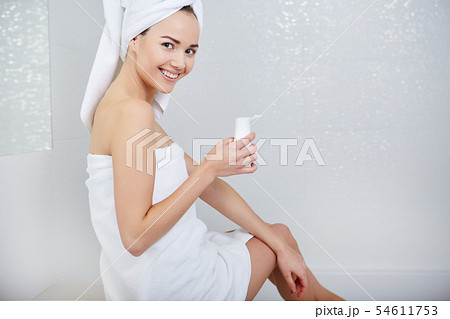 Woman Wrapped with Bath Towels, Applying Cream on 54611753