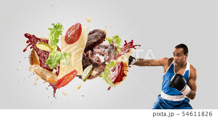 Burger's crashing by the boxer isolated on white background 54611826