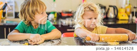 Two children a boy and a girl make cookies from dough BANNER, LONG FORMAT 54614528