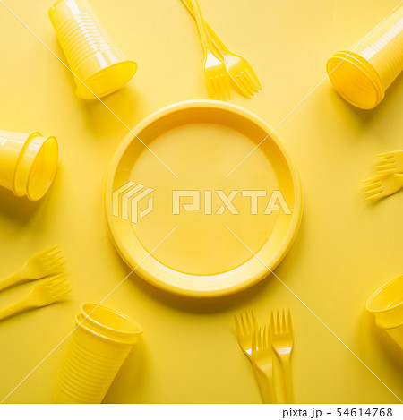 Singe use picnic utensils for recycling on yellow. Singe use picnic utensils for recycling on yellow. 54614768
