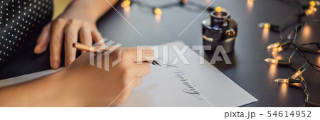 BANNER, LONG FORMAT Good morning. Calligrapher Young Woman writes phrase on white paper. Inscribing 54614952